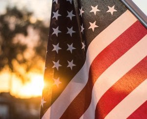 American flag with sunset background