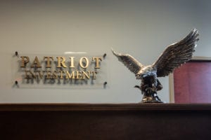 Patriot Investment plaque with statue of eagle